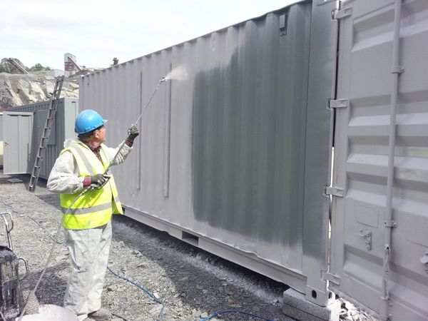 Pressure washing a container